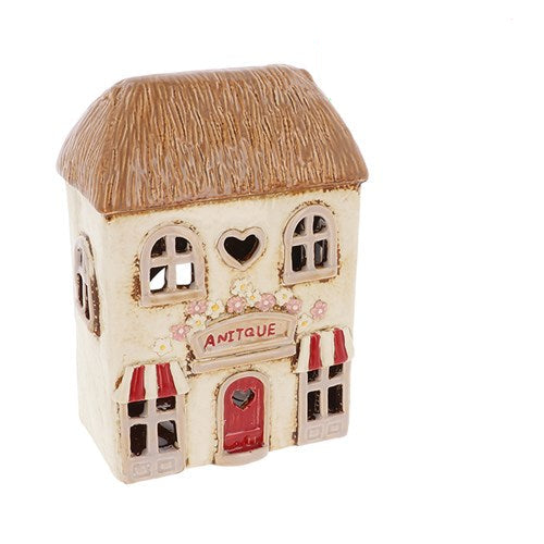 Small decorative building with 'Antique' sign, sold out notice above on white background