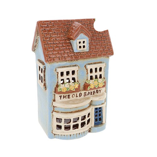 Decorative model of a bakery building with 'The Old Bakery' sign on a white background